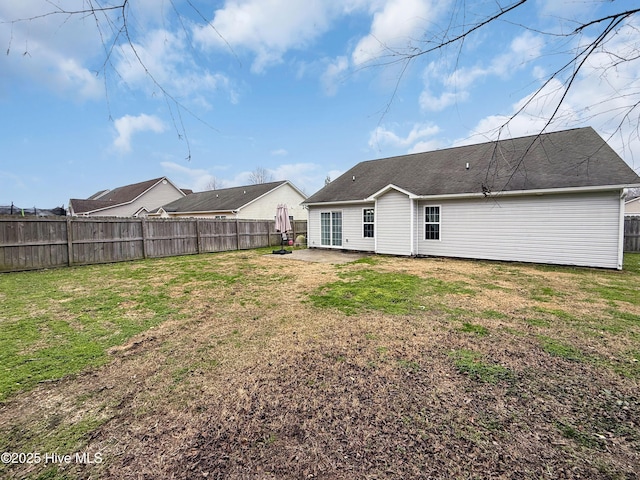 back of property featuring a yard