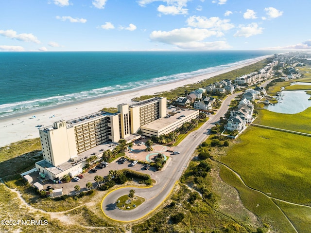 aerial view with a water view and a beach view