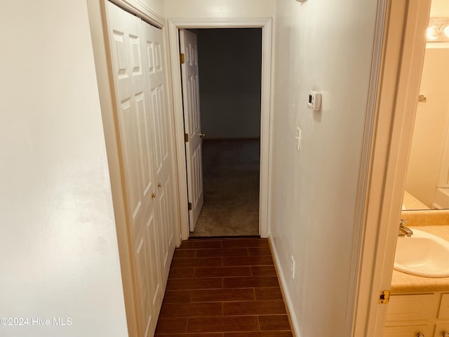 hallway with dark hardwood / wood-style floors and sink