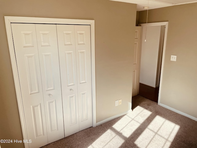 unfurnished bedroom featuring a closet and carpet