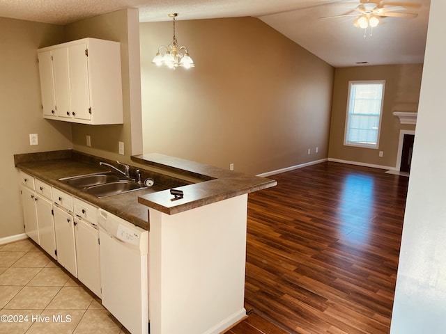 kitchen with dishwasher, white cabinets, sink, light hardwood / wood-style floors, and kitchen peninsula