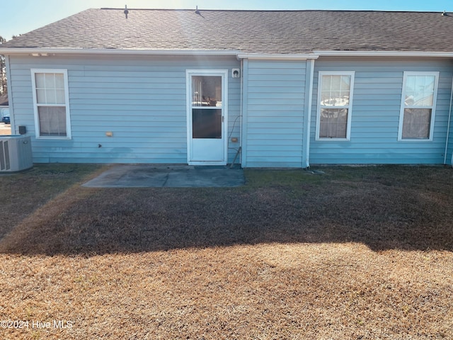 back of house featuring central air condition unit, a patio, and a yard