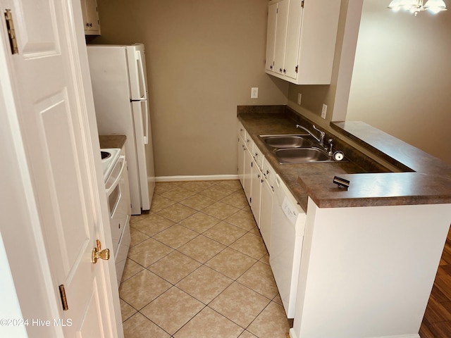 kitchen with light tile patterned floors, white appliances, white cabinetry, and sink