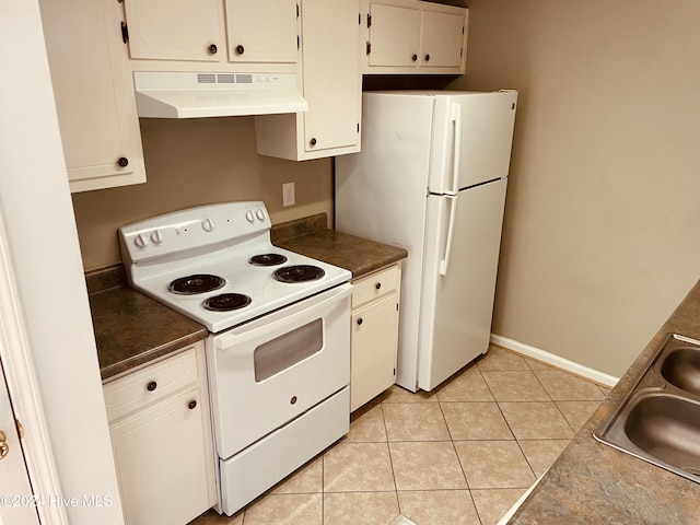 kitchen with sink, white cabinets, white appliances, and light tile patterned floors