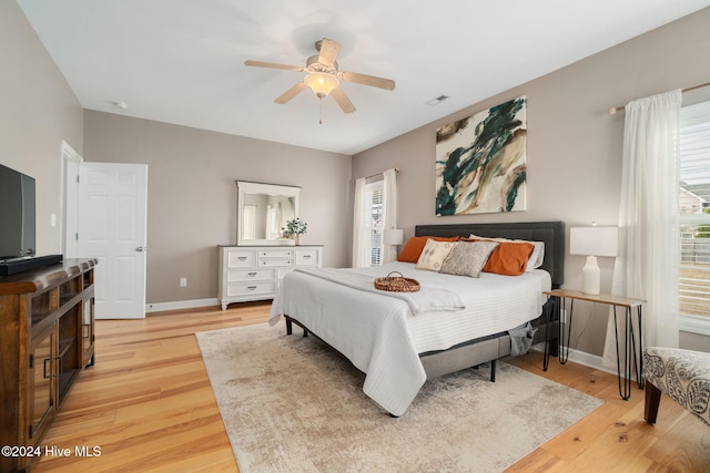 bedroom with light hardwood / wood-style flooring and ceiling fan