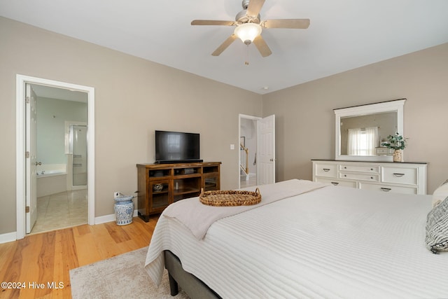 bedroom featuring connected bathroom, light hardwood / wood-style floors, and ceiling fan