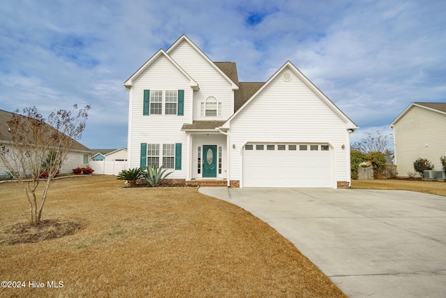 view of front property featuring a garage, cooling unit, and a front lawn