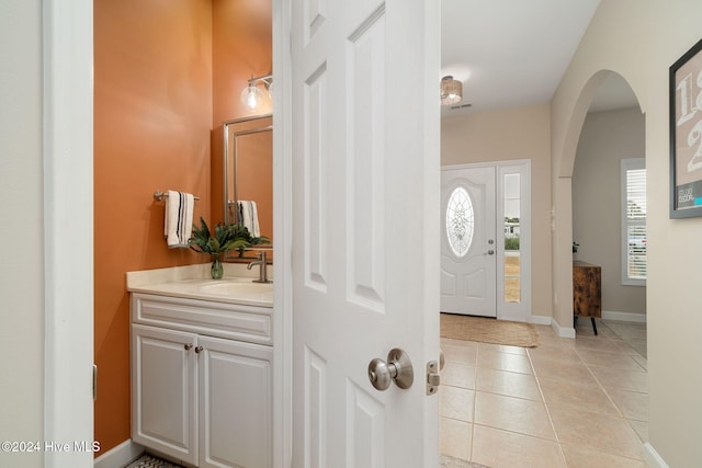 entrance foyer with light tile patterned flooring and sink