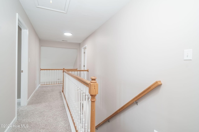 hall featuring light colored carpet