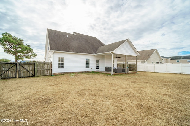 back of property with an outdoor living space and ceiling fan