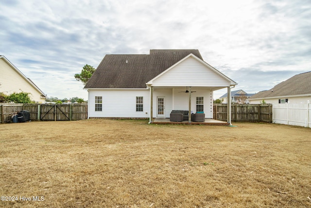 back of house featuring a lawn, a patio area, ceiling fan, and an outdoor hangout area