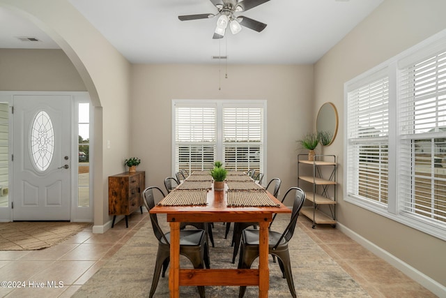 tiled dining area featuring ceiling fan