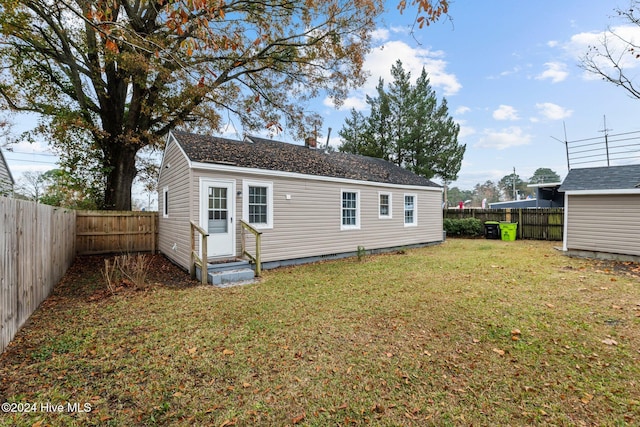 back of property featuring a lawn