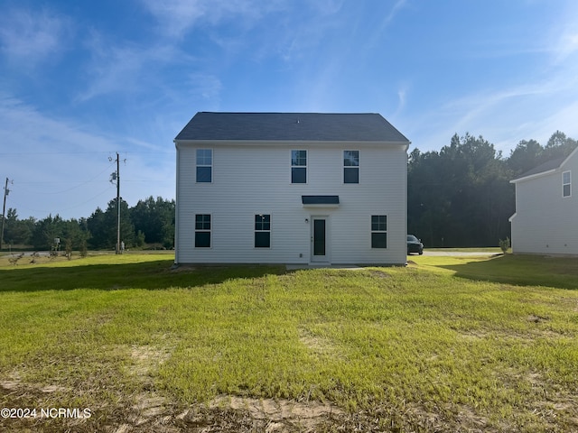 rear view of house with a yard