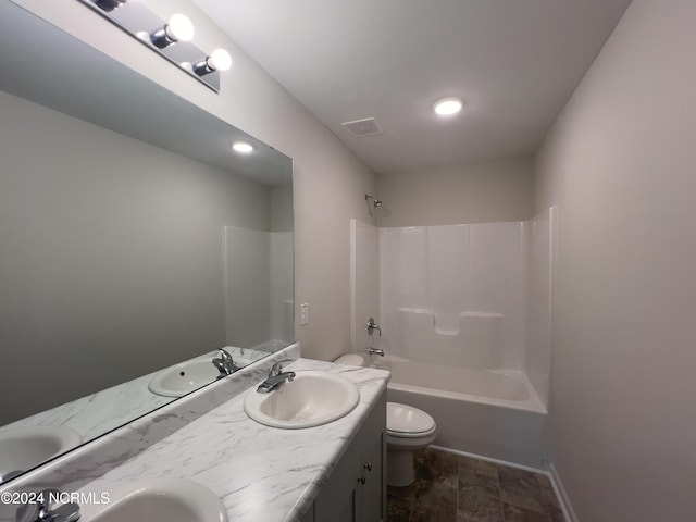 full bathroom featuring vanity, bathing tub / shower combination, and toilet