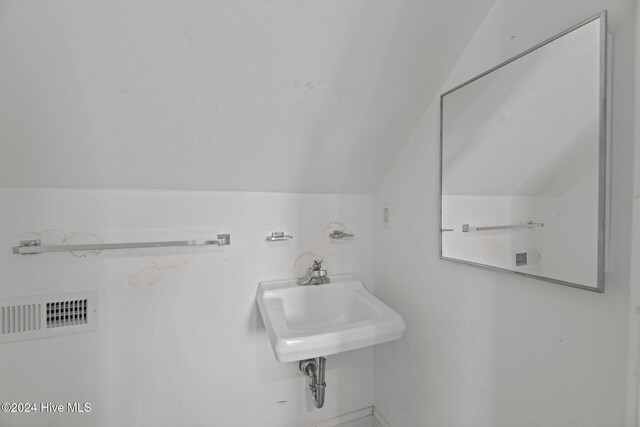 laundry area with washer and dryer, cabinets, and water heater