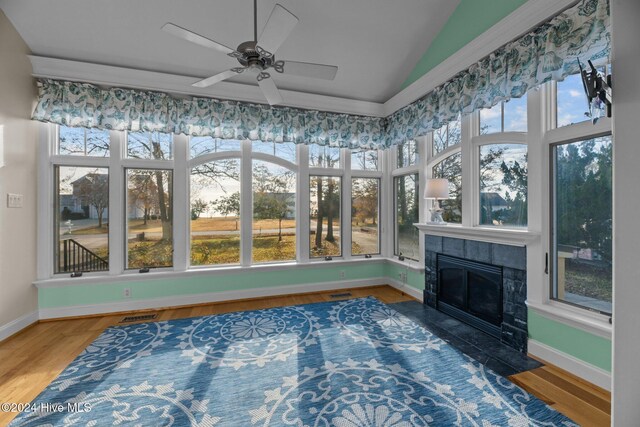 living room with hardwood / wood-style flooring, ceiling fan, a wealth of natural light, and vaulted ceiling