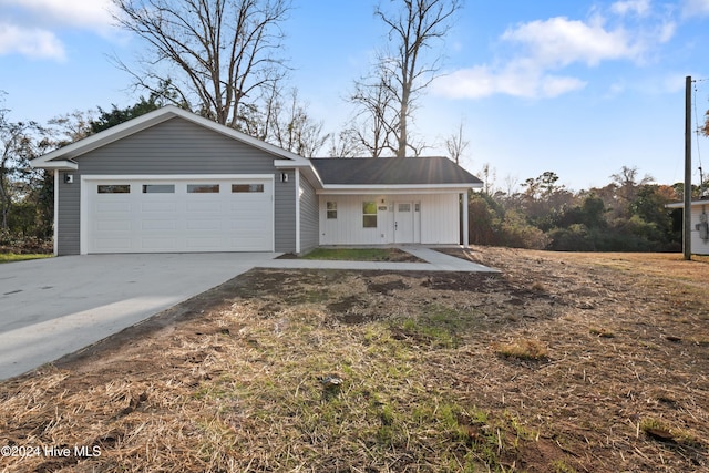 view of front of property with a porch and a garage