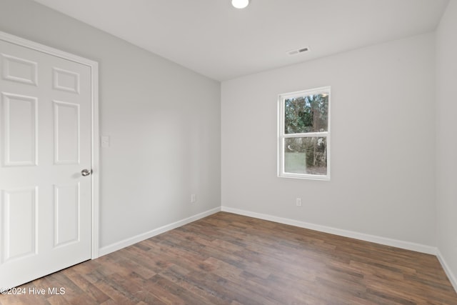 empty room with dark hardwood / wood-style floors