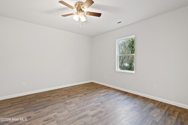 empty room featuring dark hardwood / wood-style flooring and ceiling fan