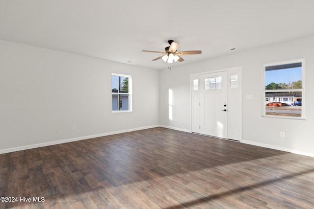 spare room with ceiling fan and dark wood-type flooring