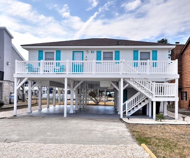 beach home with covered porch and a carport