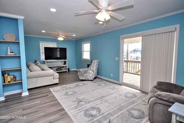 living room featuring crown molding, hardwood / wood-style floors, and ceiling fan