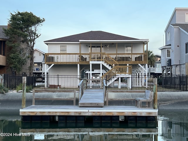 back of house with a deck with water view