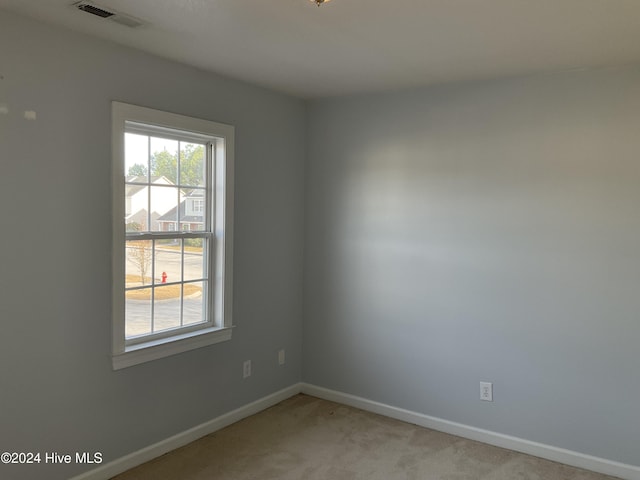 empty room featuring light carpet