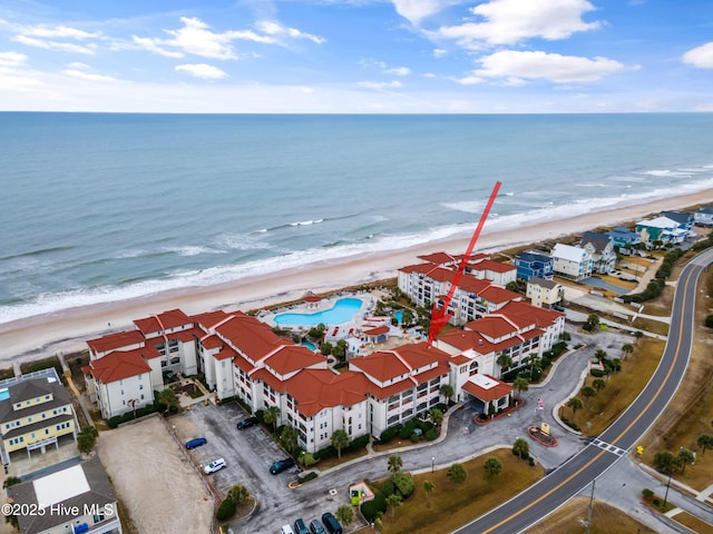 bird's eye view with a water view and a beach view