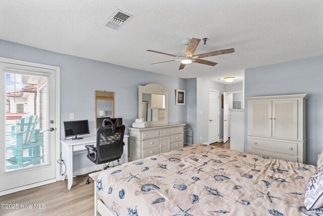 bedroom featuring a textured ceiling, ceiling fan, and dark hardwood / wood-style floors