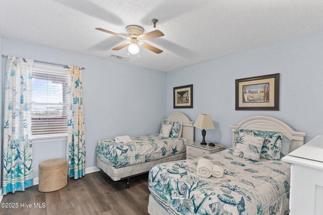 bedroom with a textured ceiling, ceiling fan, and light hardwood / wood-style flooring