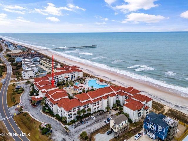 bird's eye view with a water view and a beach view