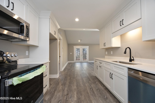 kitchen with french doors, sink, dark hardwood / wood-style floors, stainless steel appliances, and white cabinets