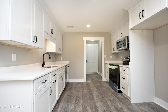 kitchen with white cabinetry, sink, dark hardwood / wood-style flooring, and stainless steel appliances