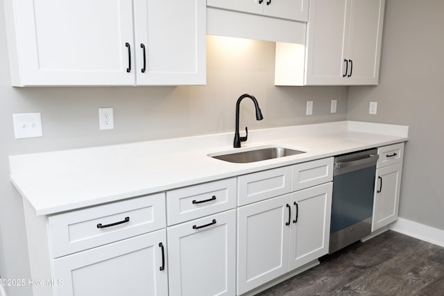 kitchen with dark wood-type flooring, dishwasher, sink, and white cabinets