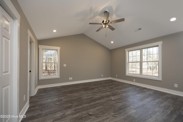 interior space with ceiling fan, plenty of natural light, dark hardwood / wood-style floors, and vaulted ceiling