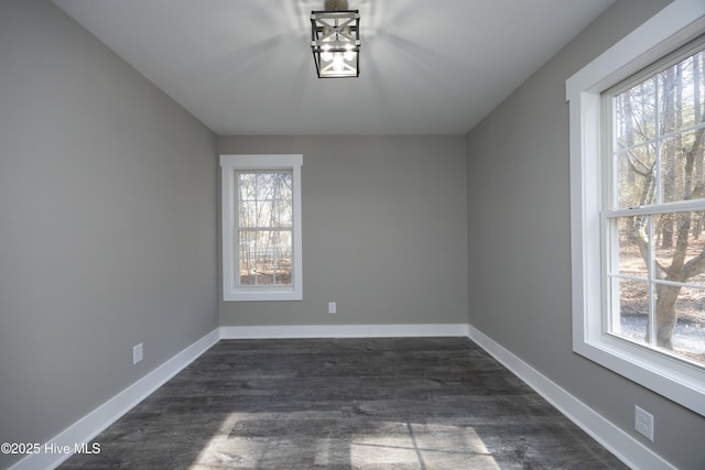 spare room with dark wood-type flooring