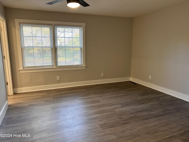 spare room with ceiling fan and dark hardwood / wood-style floors