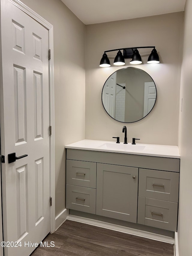 bathroom with hardwood / wood-style floors and vanity