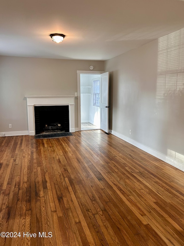 unfurnished living room with hardwood / wood-style flooring