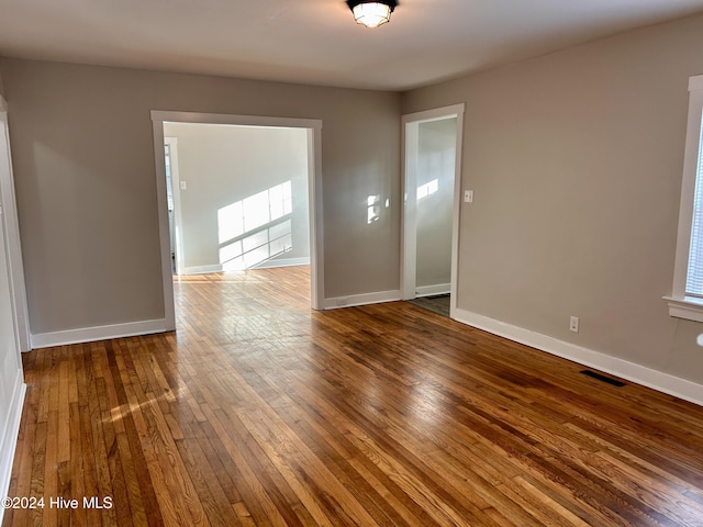 unfurnished room with hardwood / wood-style floors and a wealth of natural light