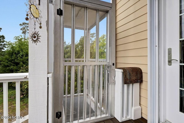 doorway to outside featuring wooden walls