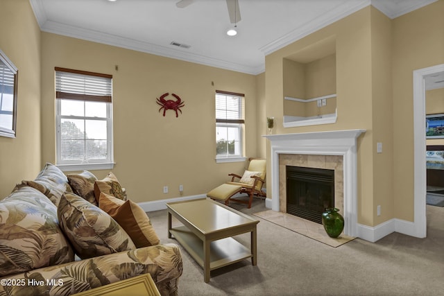 carpeted living room with a fireplace, ceiling fan, and ornamental molding