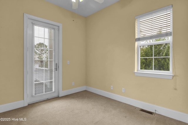 spare room with ceiling fan and light colored carpet