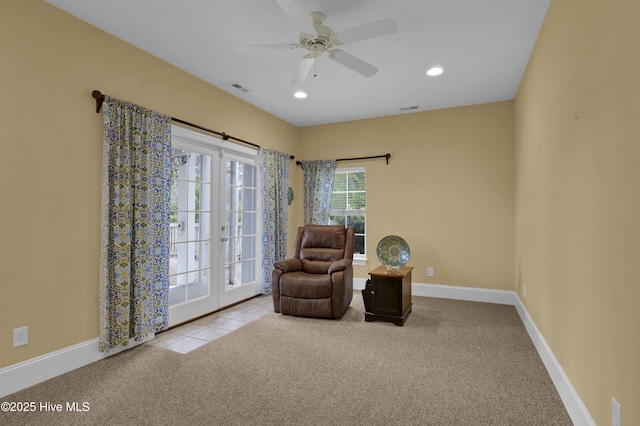 sitting room featuring ceiling fan and light colored carpet