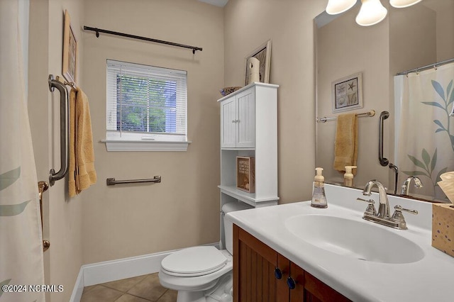 bathroom featuring tile patterned flooring, vanity, and toilet