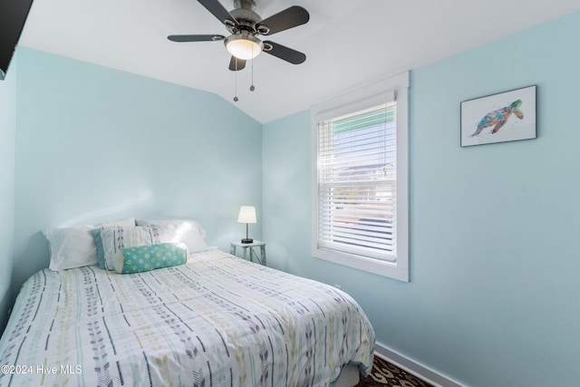 bedroom featuring ceiling fan and lofted ceiling