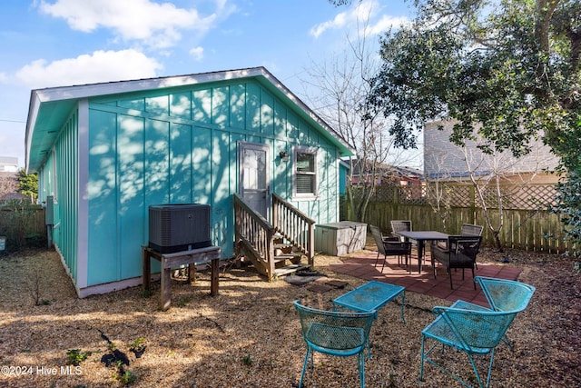 back of house with a patio area and central AC