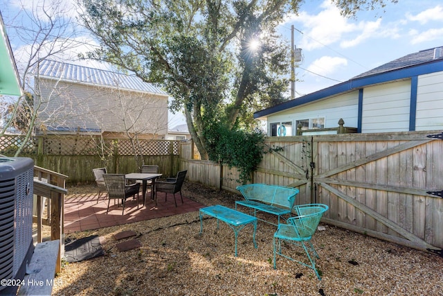 view of yard with central AC unit and a patio area